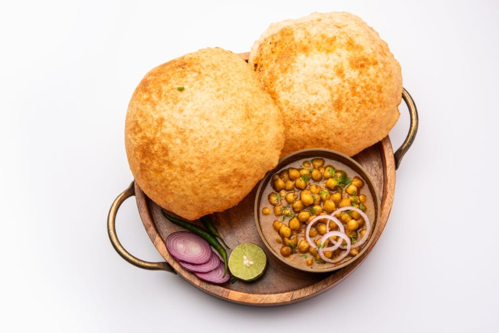 Delicious chole bhature with spicy chickpeas and fluffy bhature ready to eat